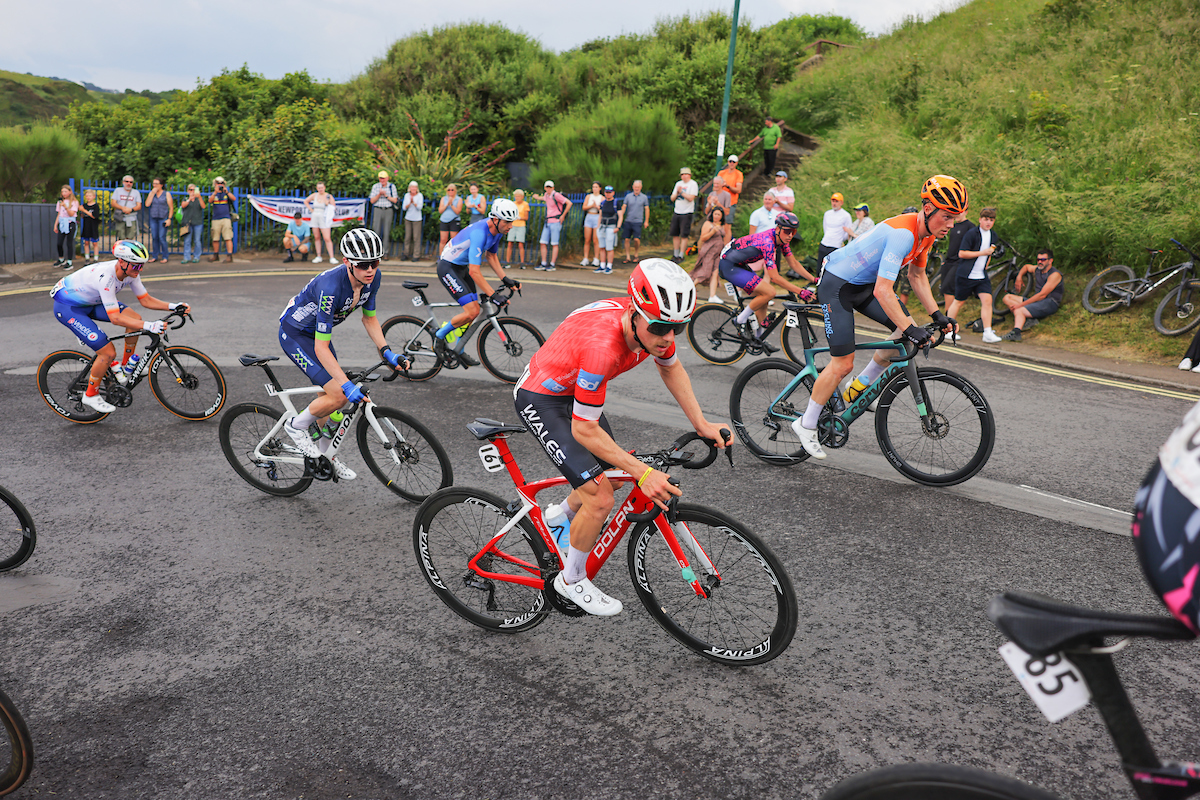 Huw Buck Jones in Wales Racing Academy kit alongside fellow cyclists